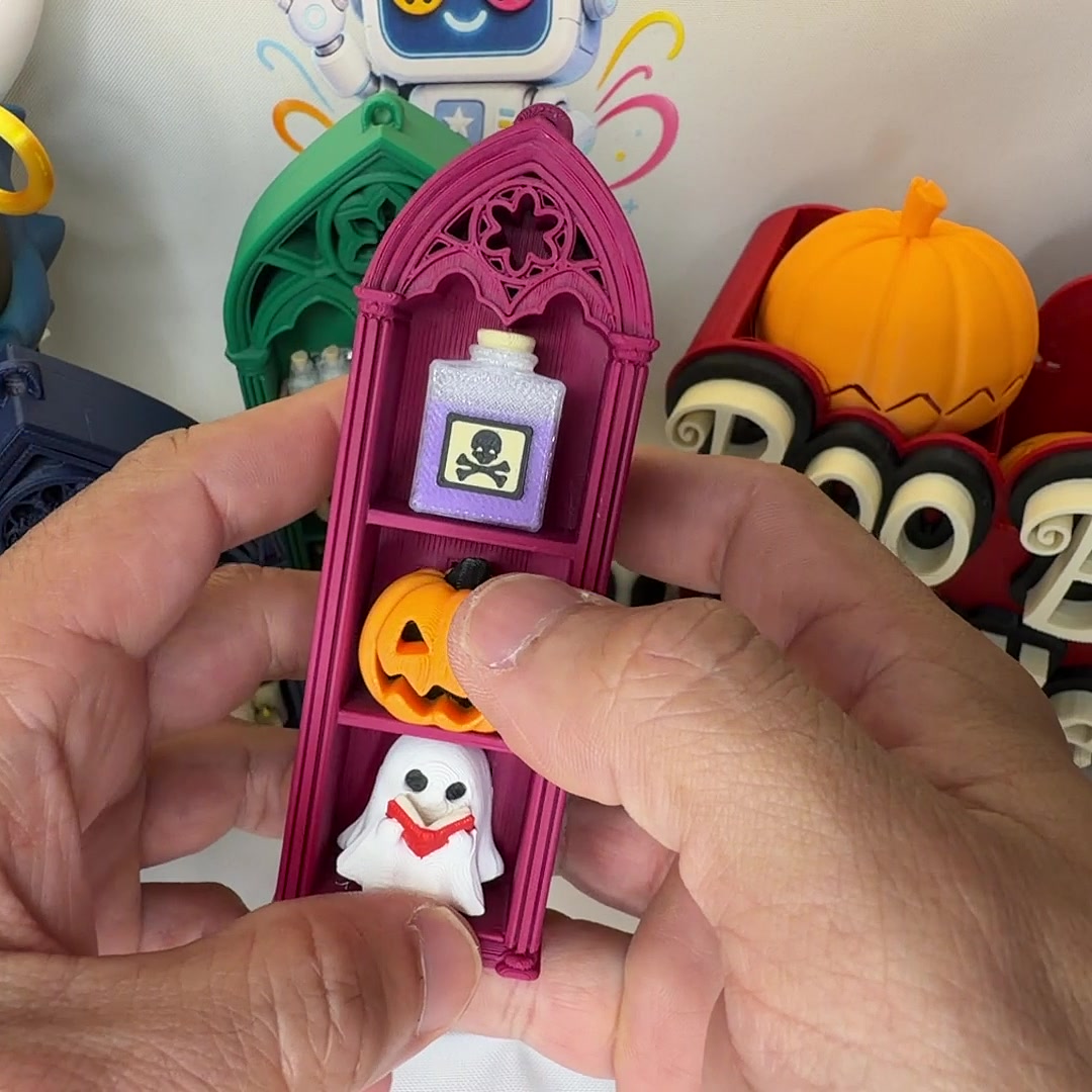 Pink coffin clicker shelf with poison bottle, jack-o-lantern, and ghost keycaps