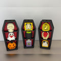 Three gothic coffin clickers with skull, ghost, pumpkin, ribcage, cauldron, birdcage and heart keycaps