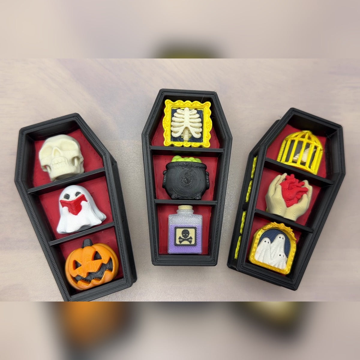 Overhead view of three filled gothic coffin clickers